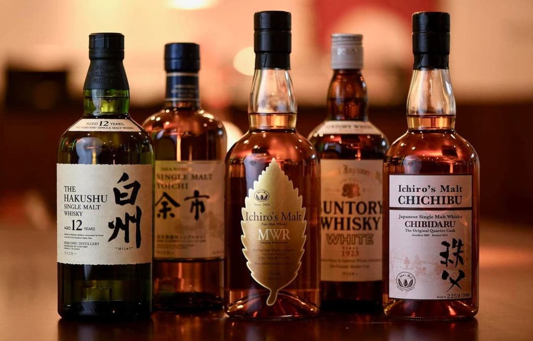 Five different Japanese whisky bottles.