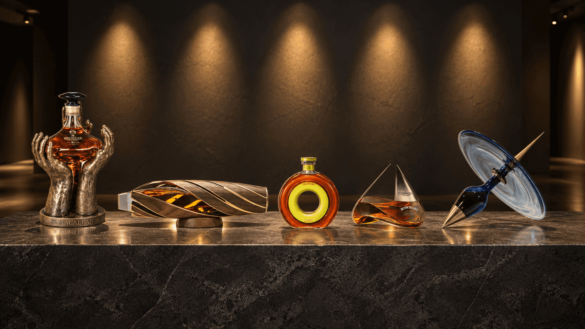 Five sculptural whisky decanters on a dark stone plinth, from Macallan The Reach to the Royal Salute Time Chamber