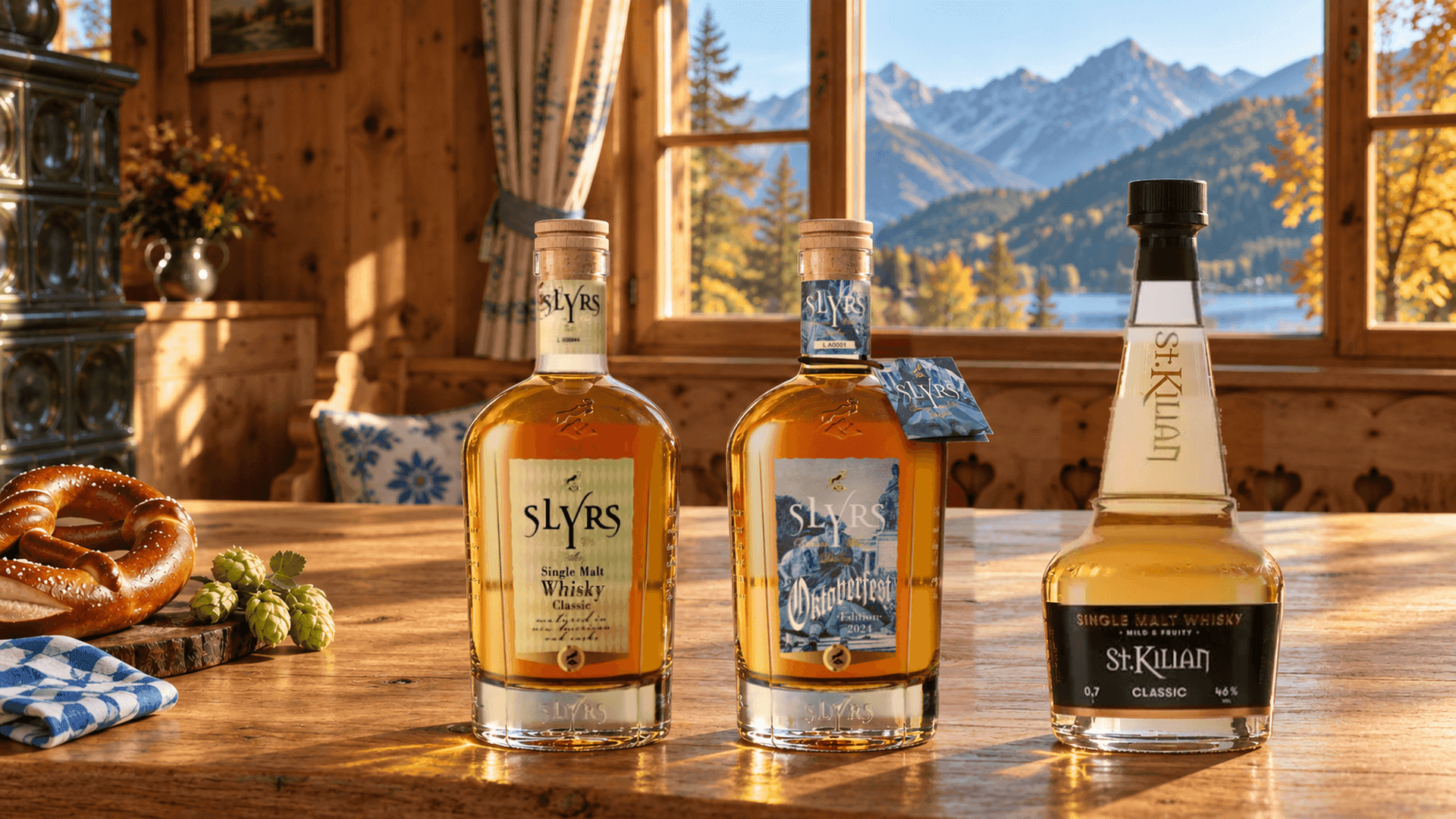SLYRS Single Malt Whisky Classic, SLYRS Oktoberfest Edition 2024 and St. Kilian Classic Mild and Fruity on an oak table in a Bavarian Stube with a pretzel, hops and a view of an Alpine lake